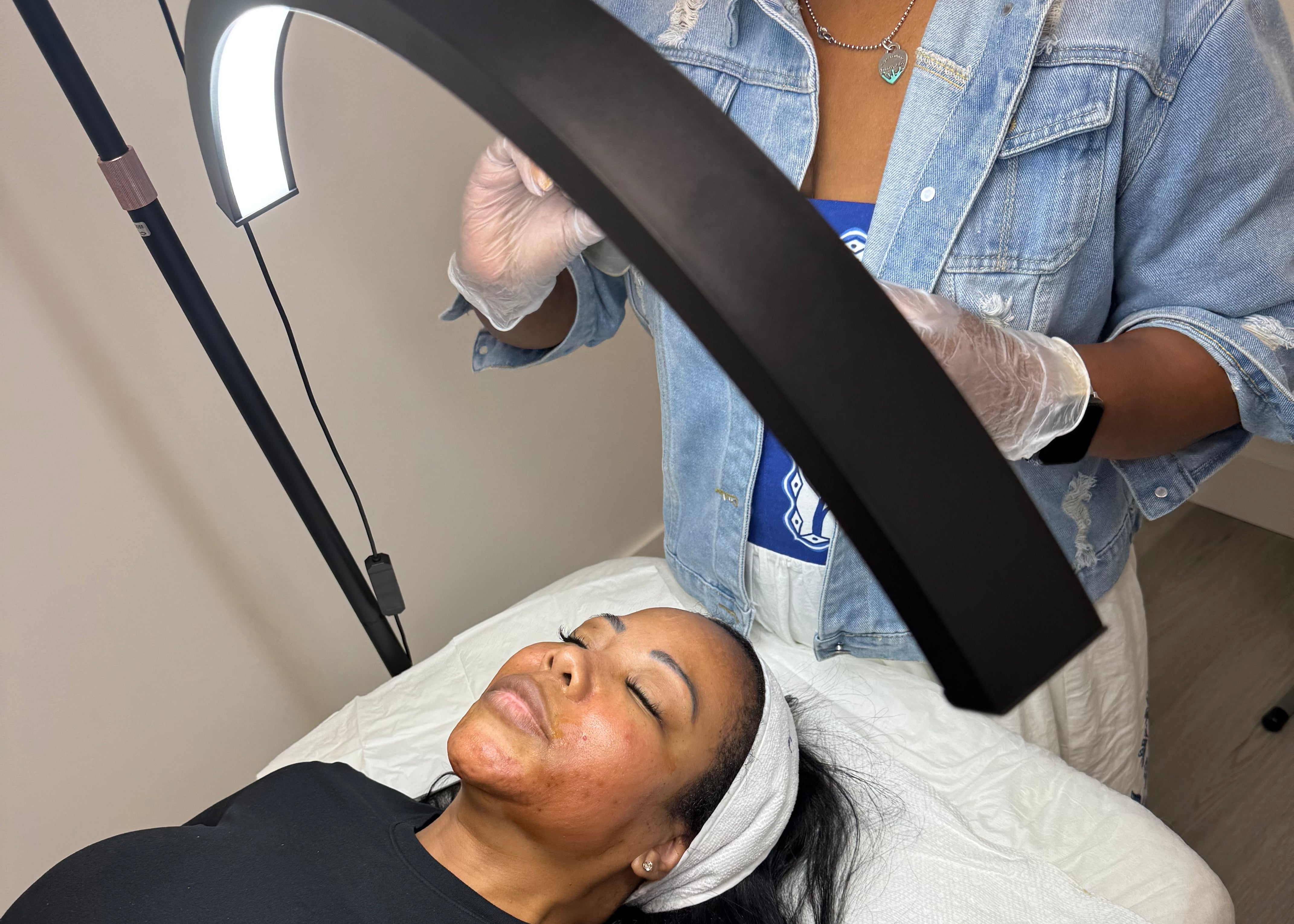 Person receiving a facial treatment with a professional setup.